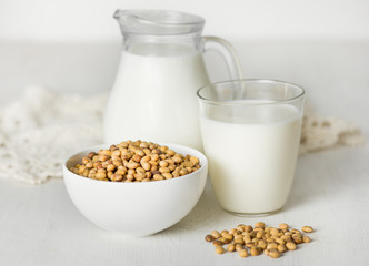 Soy milk  and soybeans on a white table