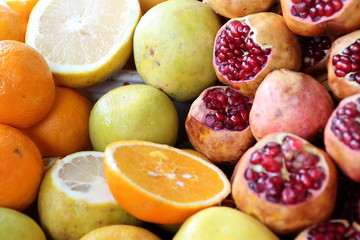 Naklejka na ściany i meble Fruit background: orange, apple, pomegranate and lemmon