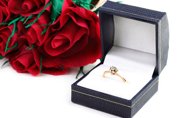 Diamond ring and bouquet paper red roses 
