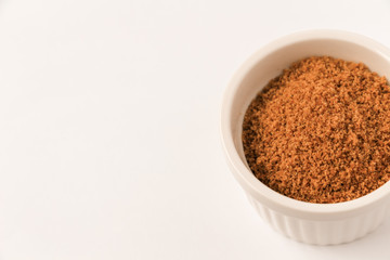 Coconut sugar in a cup with white background