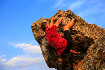 Young man climbing on a wall