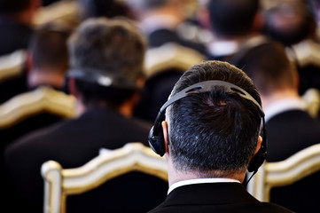 People using headphones during conference