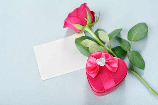 Blank greeting card, gift and rose