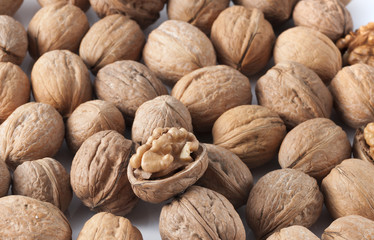 pile of walnuts in the foreground represent a healthy diet