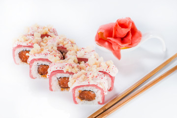 closeup roll sushi with chopsticks and ginger (shallow DOF)