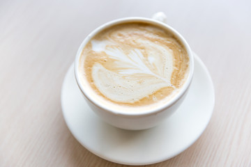 Hot art Latte Coffee in a cup on wooden table