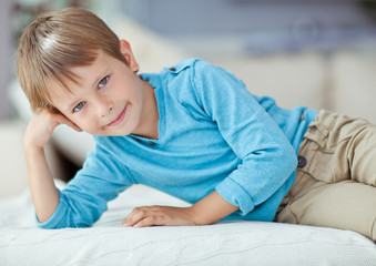 Fototapeta premium Happy kid are lying in the bed 