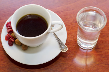 Espresso. White cup of coffee with glass of water