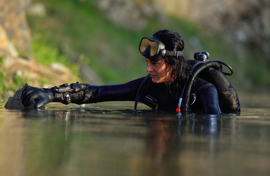beautiful caucasian diver woman in the water