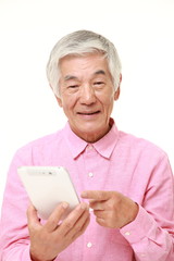senior Japanese man using tablet computer