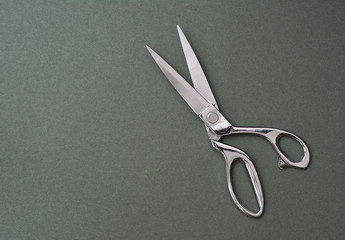 Professional tailor scissors on green
