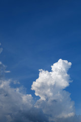 large cumulus cloud on clear blue sky background