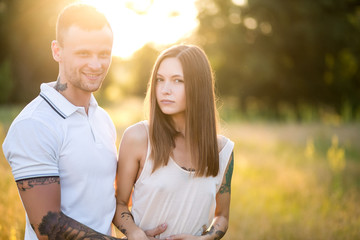Naklejka premium Beautiful young loving couple hugging in nature. The concept of good mood
