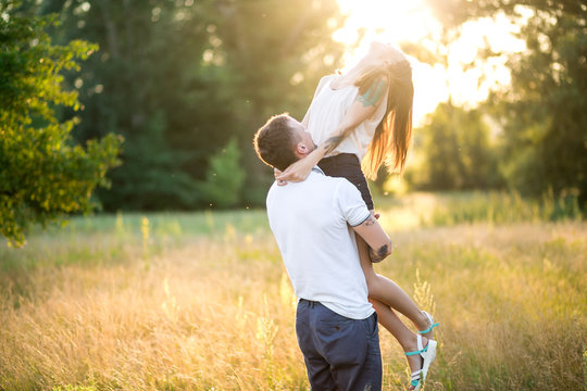 Beautiful young loving couple hugging in nature. The concept of good mood