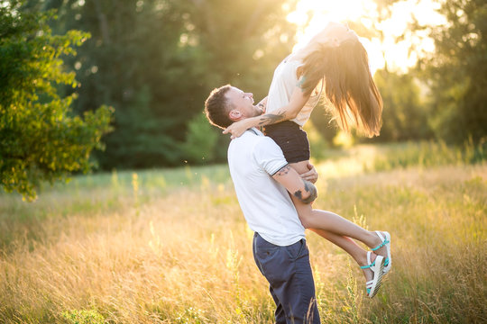 Beautiful young loving couple hugging in nature. The concept of good mood