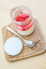 Beautiful strawberry dessert in a jar on light Board