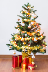blur background, light celebration on christmas tree with gift box in living room