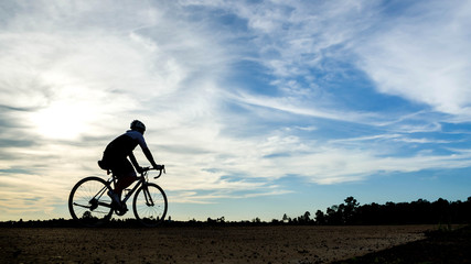 Fototapeta na wymiar silouette cyclist man at sunset