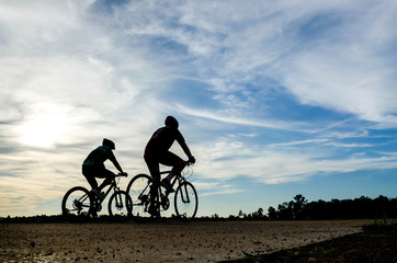 silouette cyclist man at sunset