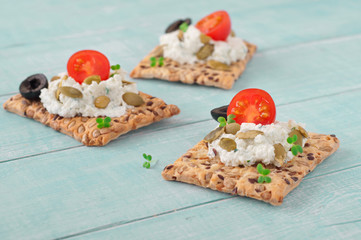 canape made cookies with cheese, cherry tomatoes and black olive