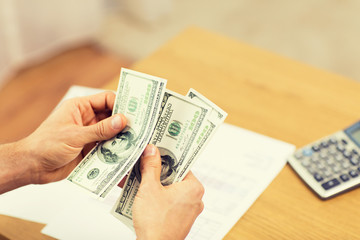 close up of man hands counting money at home