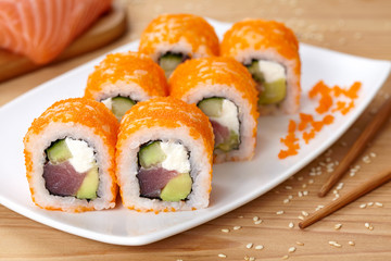 Philadelphia sushi roll with tuna, avocado, cream cheese, cucumber and tobiko caviar.