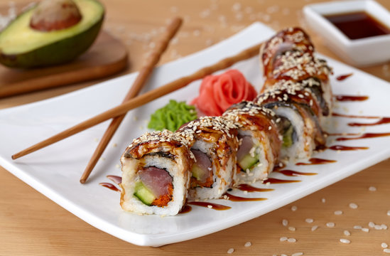 Golden dragon sushi roll with tuna, eel, cucumber, sesame seeds and tobiko caviar