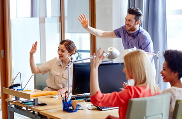 happy creative team waving hands in office - Powered by Adobe