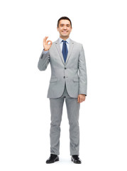 happy businessman in suit showing ok hand sign