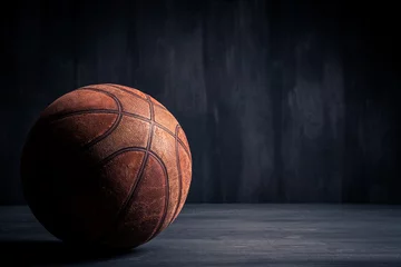 Rolgordijnen Old basketball ball on a black background © BortN66