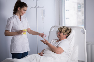 Nurse giving medicine to patient