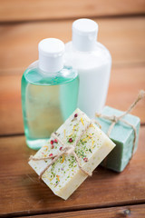 Fototapeta na wymiar close up of handmade soap bars and lotions on wood