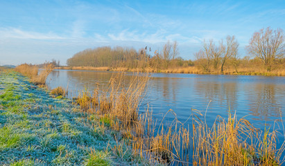 Canal through a frozen landscape in winter