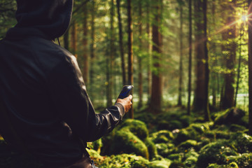 Man taking pictures in the woods