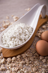 Cottage cheese, eggs on the background of scattered muesli.