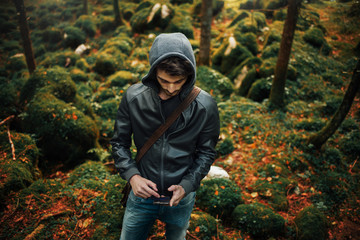 Young man posing in the woods