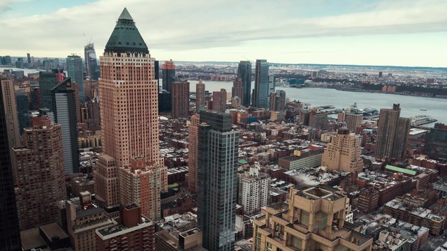 Midtown Manhattan skyline from sunrise to mid morning in timelapse with a view of  One World Plaza building and Hudson River ships