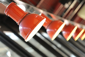 Row of red pendant lights inside restaurant