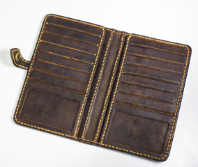Brown leather wallet isolated on white background. Hand made leather man wallet with many slots for credit cards inside of wallet.