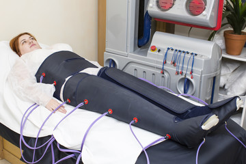 woman at the clinic for the treatment of pressure therapy procedure