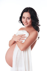 Smiling pregnant woman posing naked over white. Isolated. Maternity. Motherhood. Healthy lifestyle.