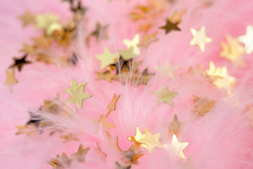 golden stars in a pink plumage background