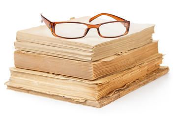 eyeglasses on a stack of old books