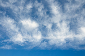 Cloudscape over horizon. Blue sky and white clouds.