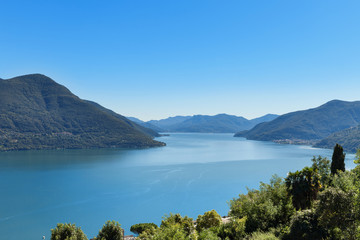 Fototapeta premium Panoramic of Lake Maggiore, part of Italian Switzerland. A very bland sunny day in pina estat with an intense blue lake.