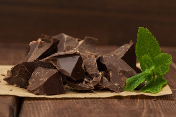 Dark chocolate with cacao on wooden table