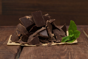 Dark chocolate with cacao on wooden table