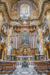 Fototapeta na wymiar ROME, ITALY - MARCH 25, 2015: Side altar of baroque church Basilica dei Santi Ambrogio e Carlo al Corso with the altarpiece God the Father Being Worshipped by Angels by Tommaso Luini (1601 – 1636)