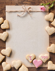 Greeting card mock up for Valentine's day with cookies on wooden background. View from above. Valentines Day concept