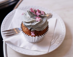 Cup cake on plate with fork napkin